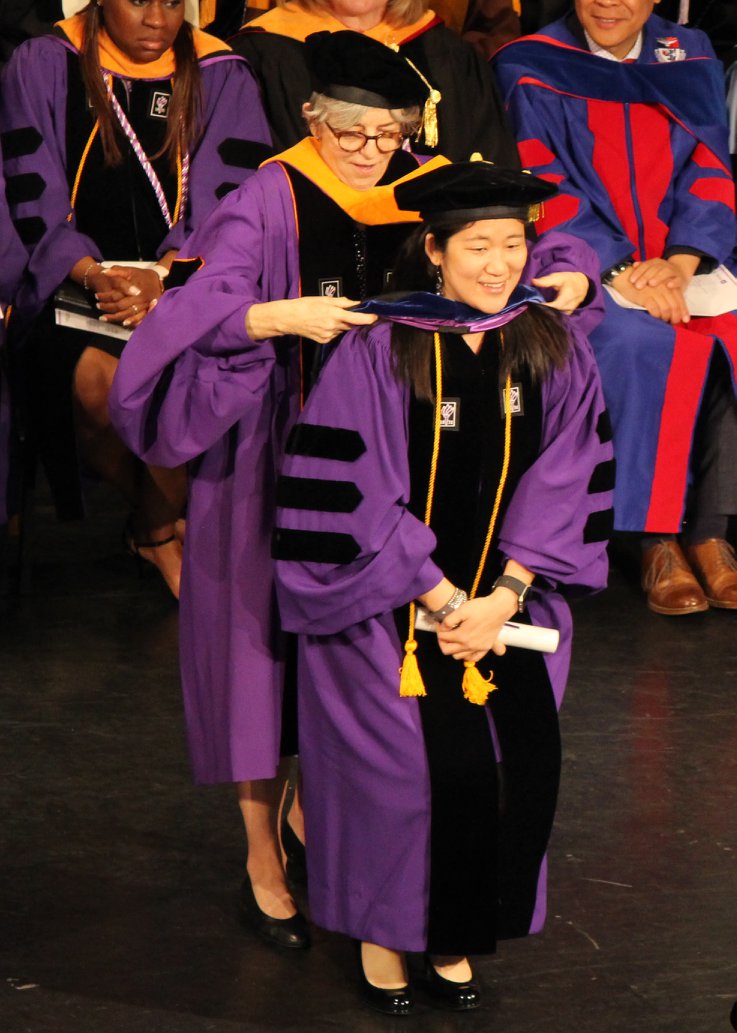 PhD graduate Jin Jun being hooded at graduation