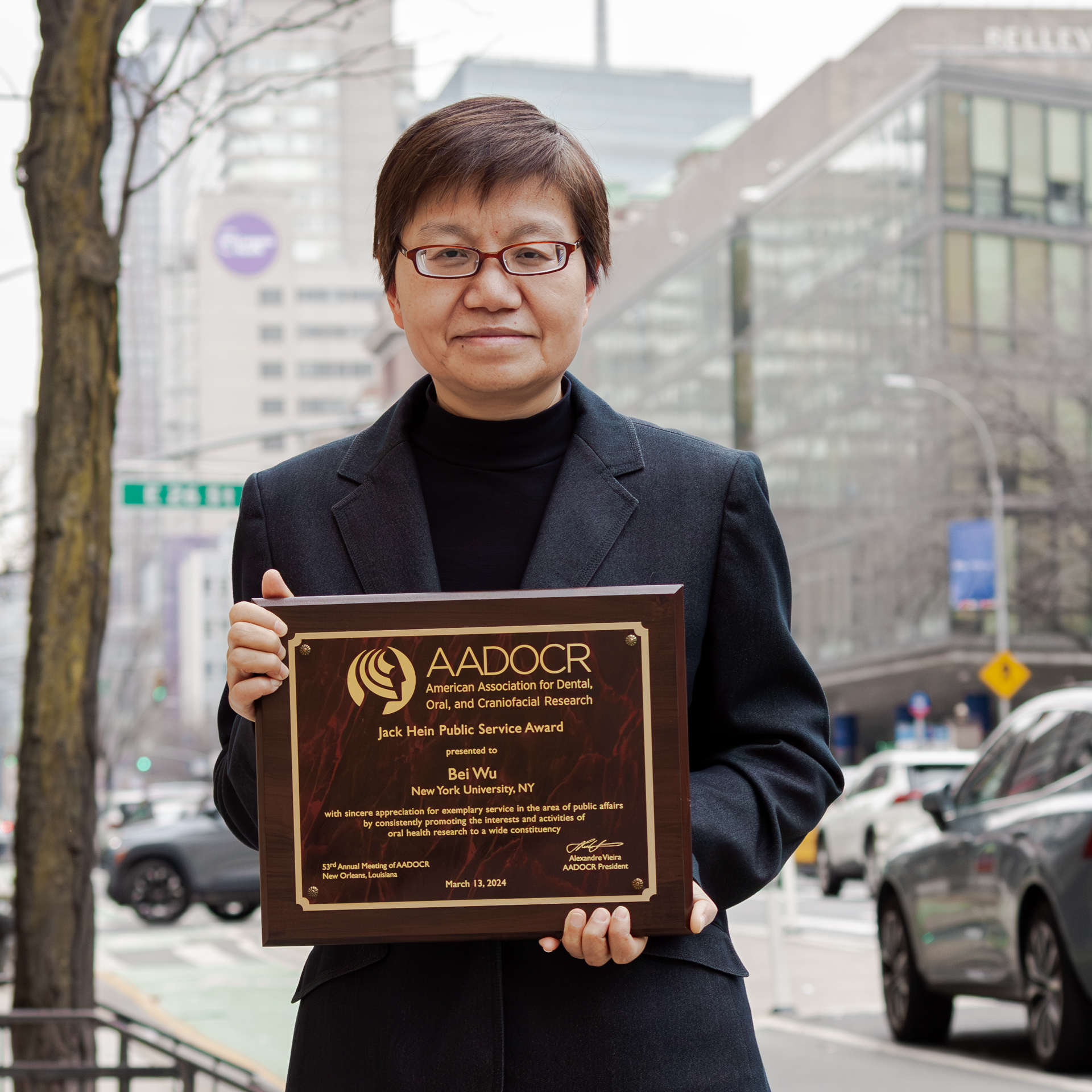 Bei Wu portrait holding award