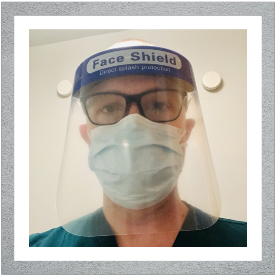 Day wearing PPE face shield
