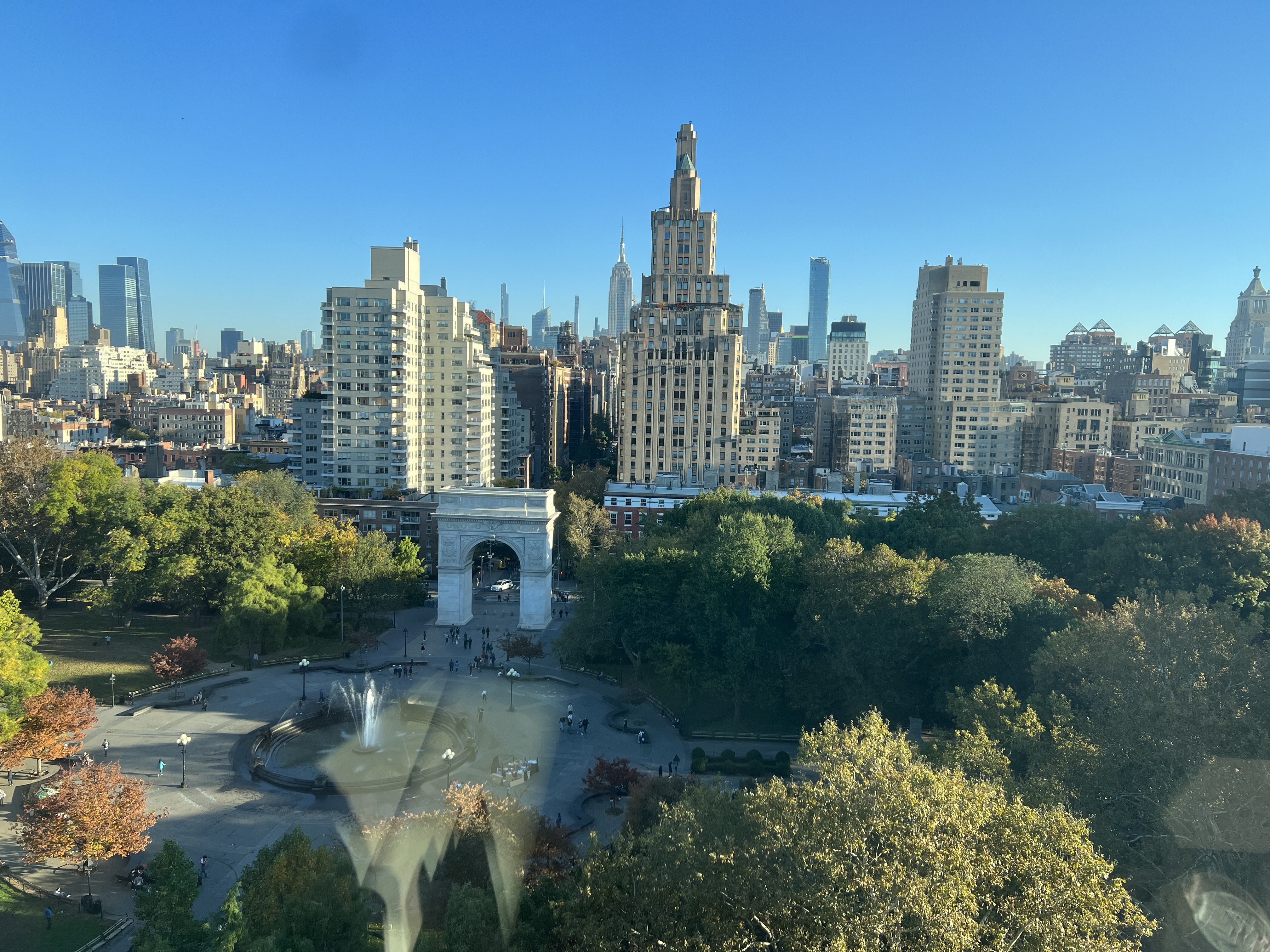 Aerial view of Washington Square Park with city skyline in the background