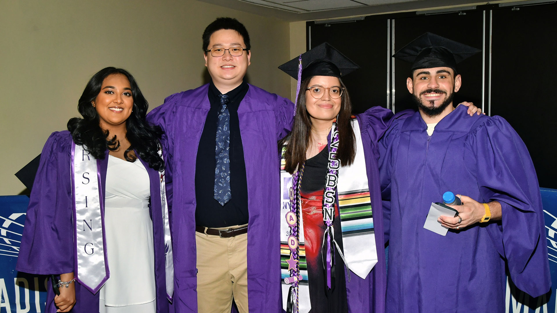 Students in purple graduation attire