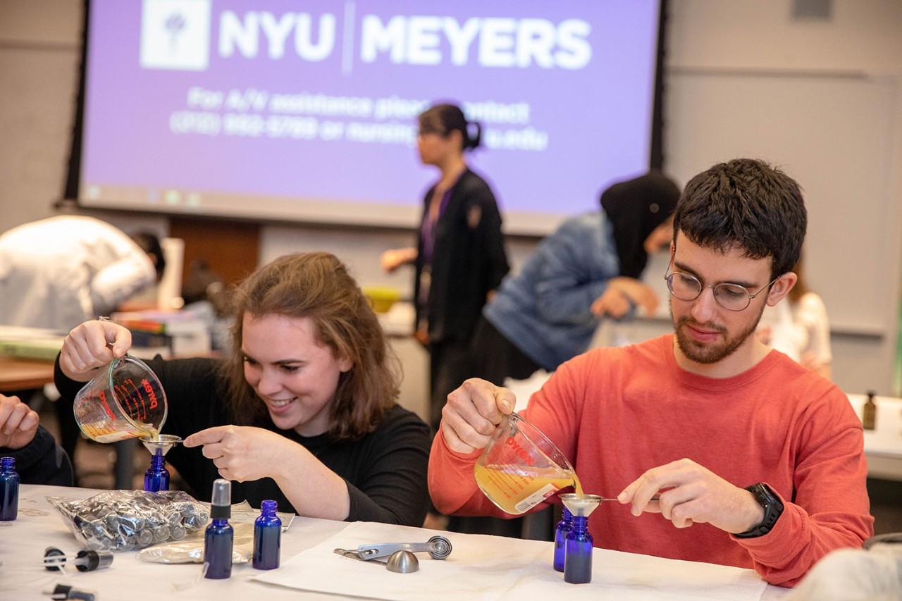 Students pouring herbal concoctions