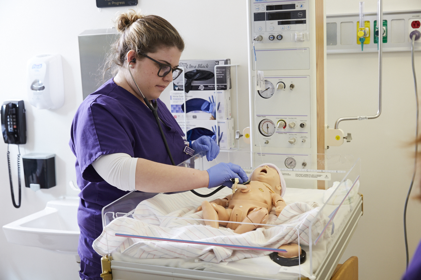 Student participates in simulated maternity class