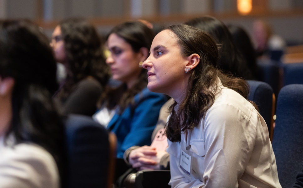 side profile of audience members listening to a speaker