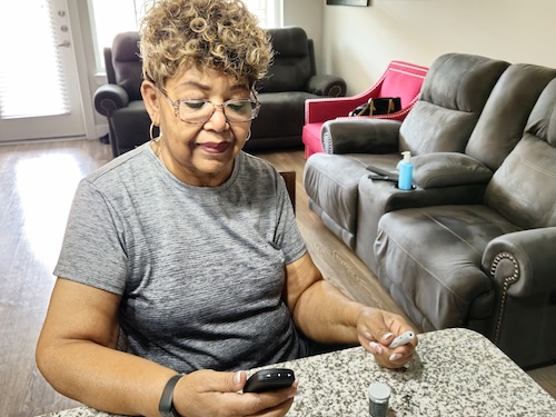 Women looking at diabetes monitor 