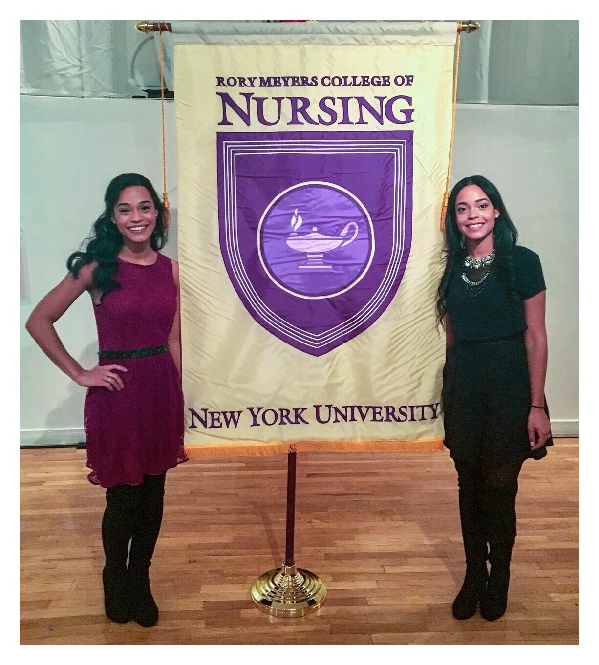 Paradis sisters pose with NYU Nursing banner