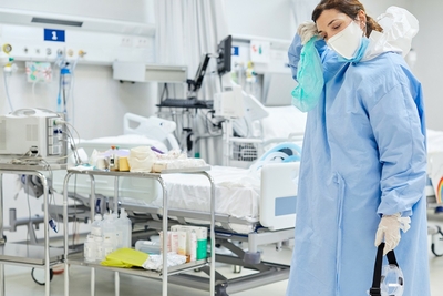 Nurse in lab gown, tired and stressed 