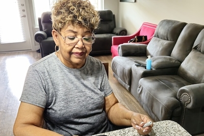 Women looking at diabetes monitor 