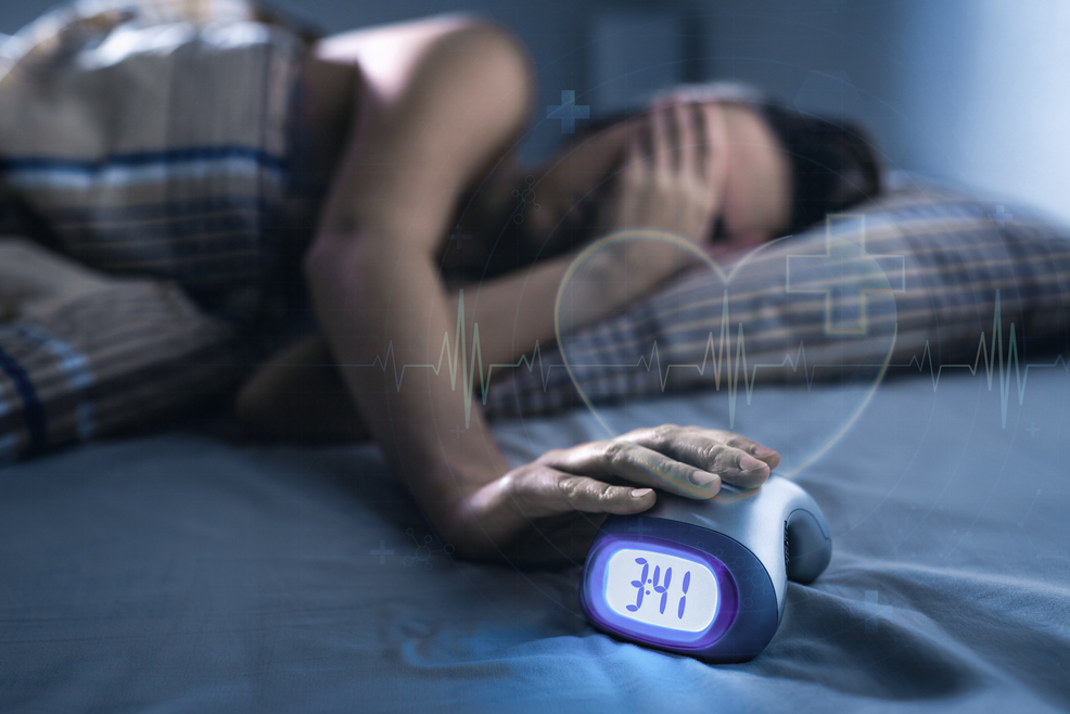 women can't sleep and alarm clock