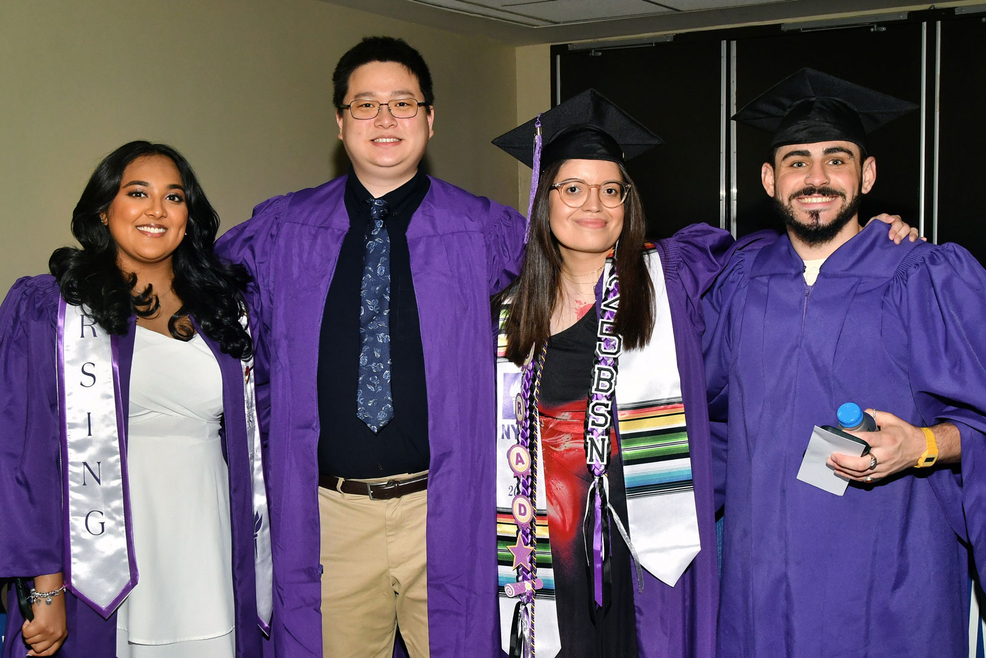 Students in purple graduation attire