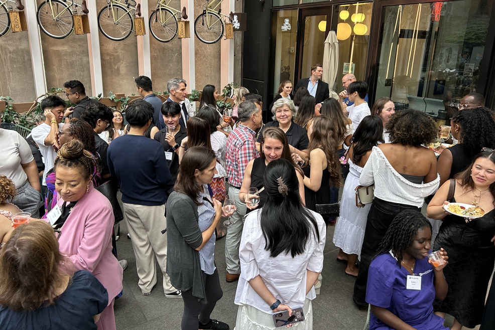 Alumni and staff outside hotel congregating