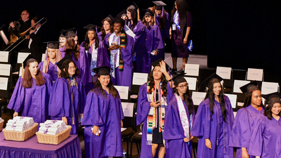 Graduates walk across stage