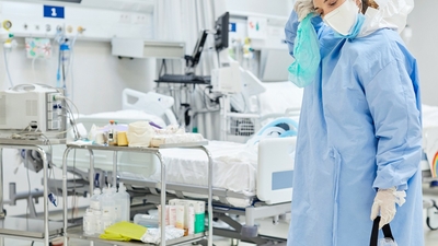 Nurse in lab gown, tired and stressed 
