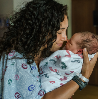 Mother cuddling her newborn baby
