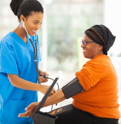 Nurse taking female patient's blood pressure