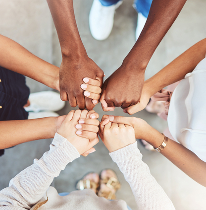 four people holding hands in a circle